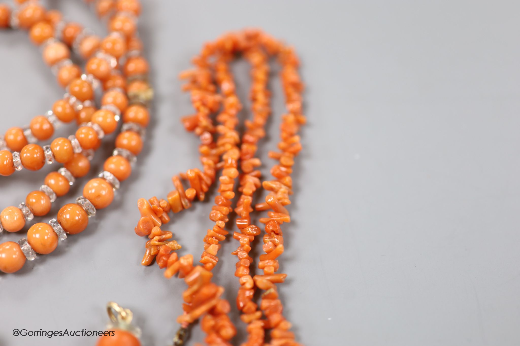 Four assorted coral bead necklaces, largest 148cm and a coral bead bracelet.